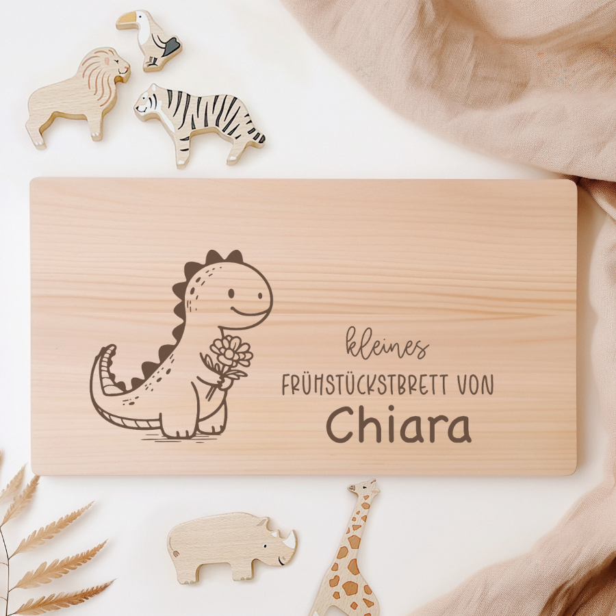 Frühstücksbrettchen Dino aus Holz mit Dino-Design und personalisiertem Namen.