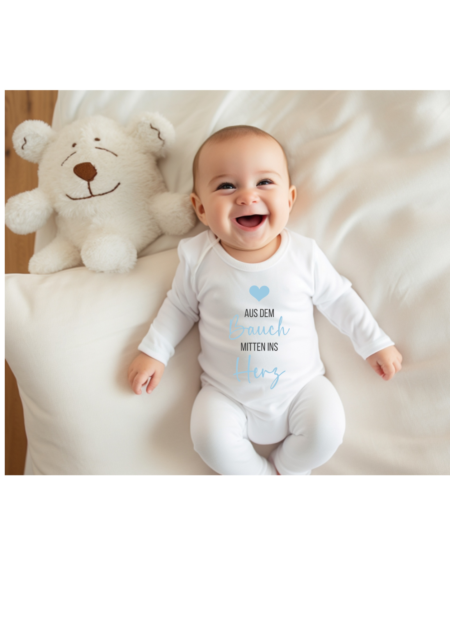 Smiling baby wearing a comfortable babybody with a stuffed bear.