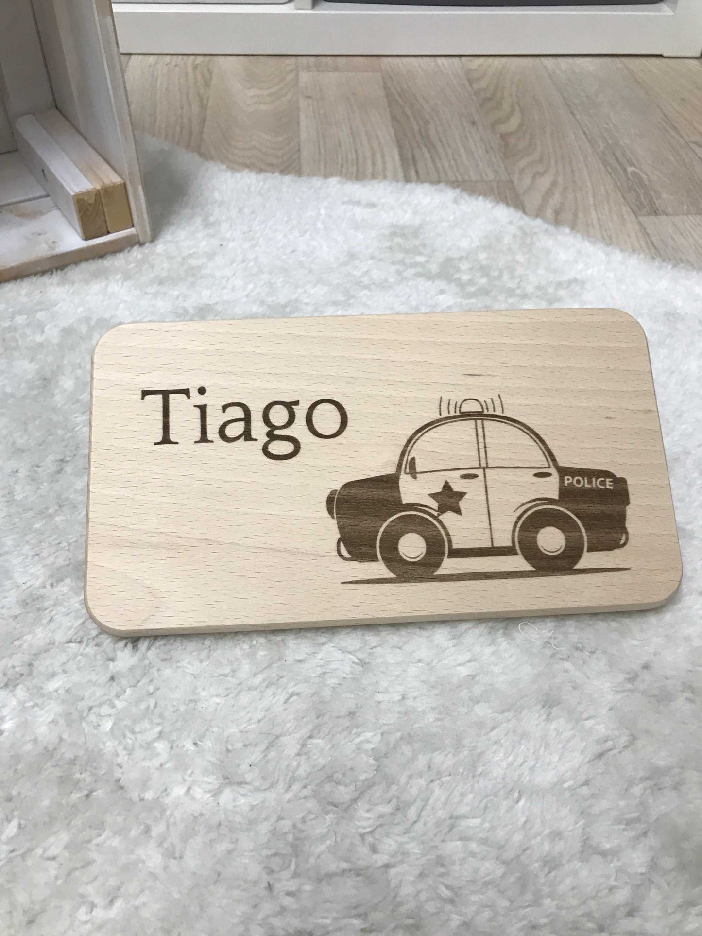 Wooden breakfast board with engraved police car design and the name "Tiago".
