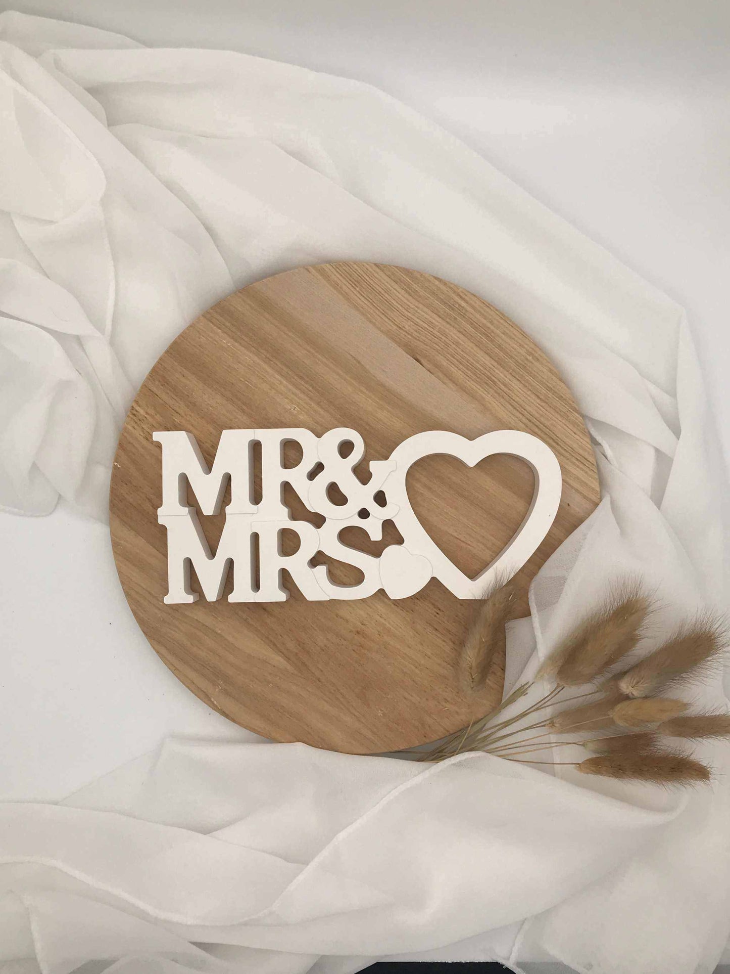 Edler "Mr & Mrs" Schriftzug, handgefertigt aus Raysin, als Hochzeitstischdekoration auf Holzteller.