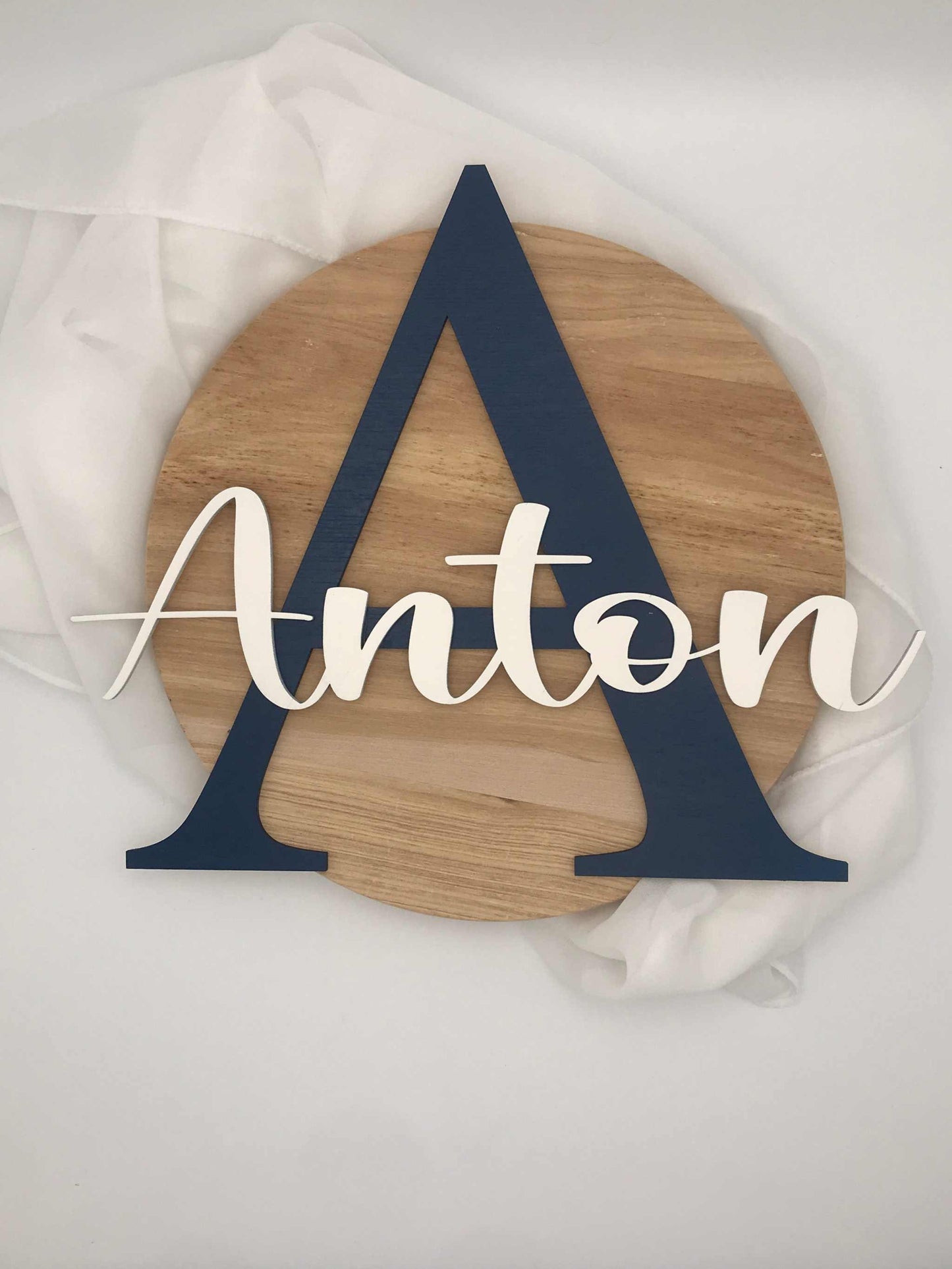 Personalized wooden door sign for a child's room with the name "Anton" featuring a large initial 'A' and playful design.