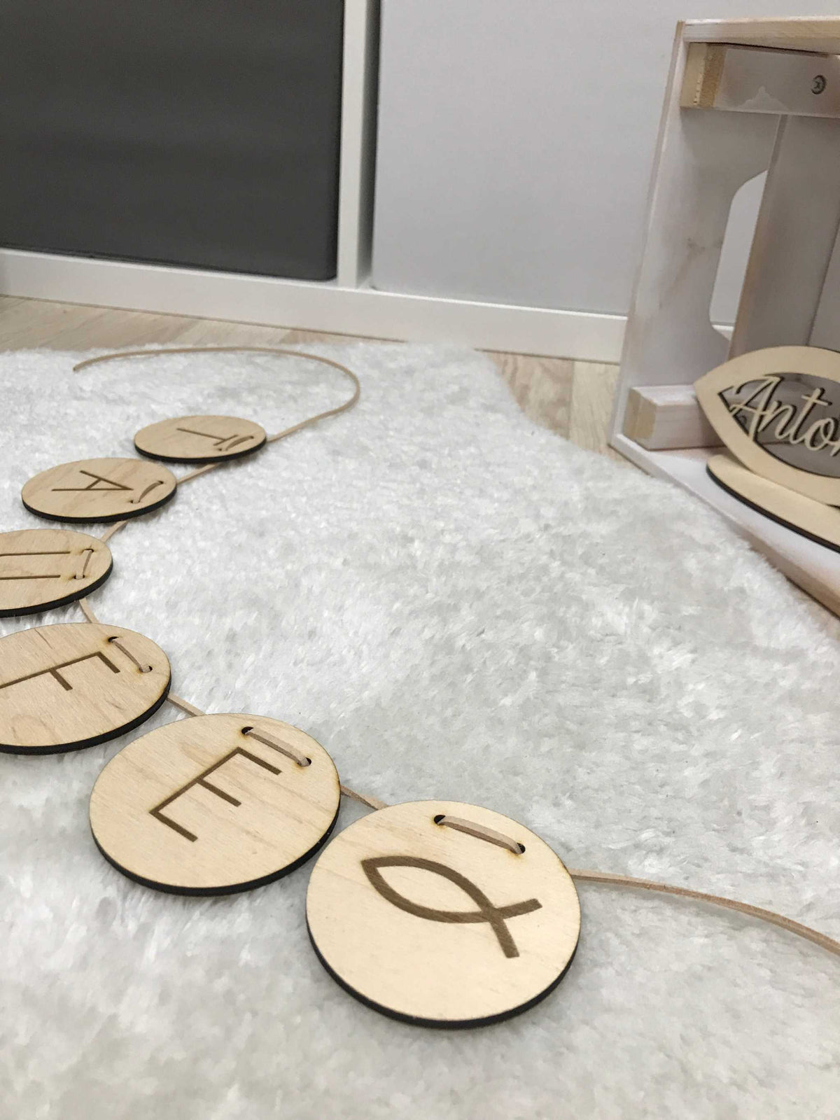 Personalisierte Wimpelkette aus Holz mit gravierten Buchstaben auf Lederband für Kinderzimmerdekoration
