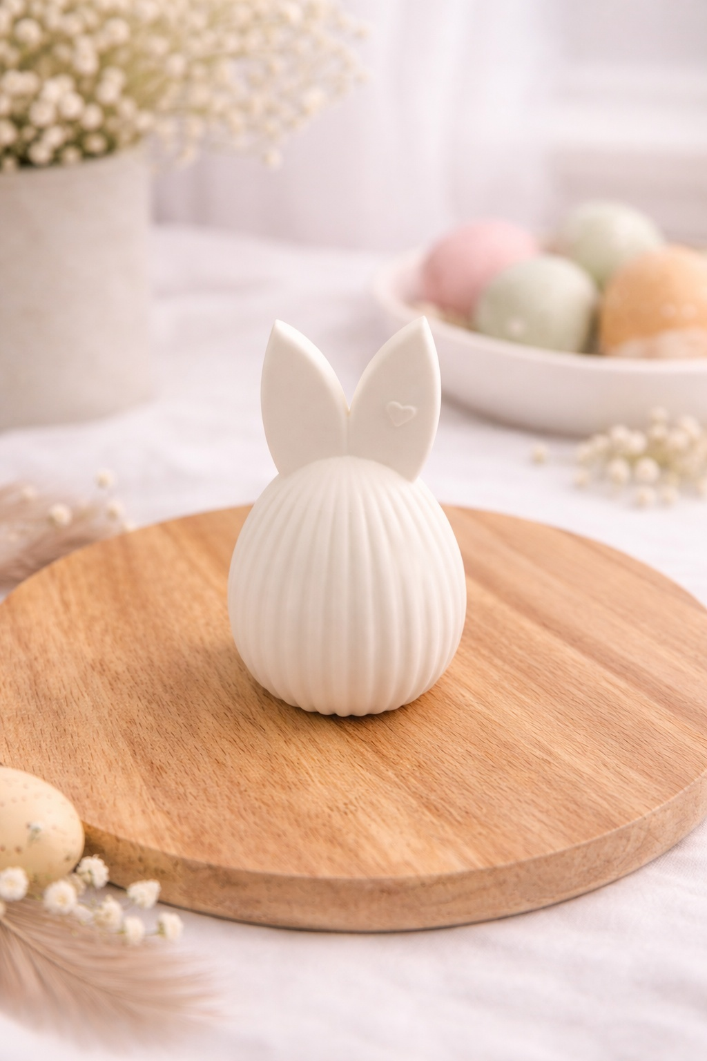 Weißes Osterhasen-Ei aus PLA mit feiner Riffelstruktur, schlichte Osterdeko in natürlicher Umgebung