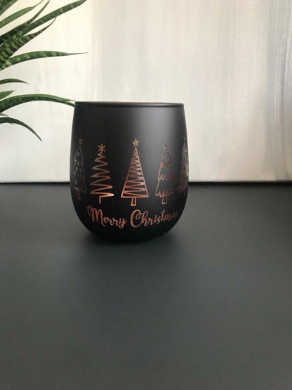 Weihnachtliches Windlicht aus Glas in schwarz-roségold mit gravierten Motiven, ideal als Geschenk oder Dekoration.