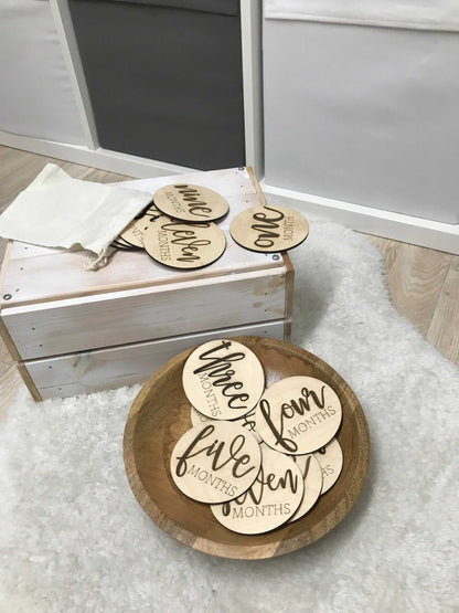 Wooden milestone discs set for baby photos celebrating monthly milestones.