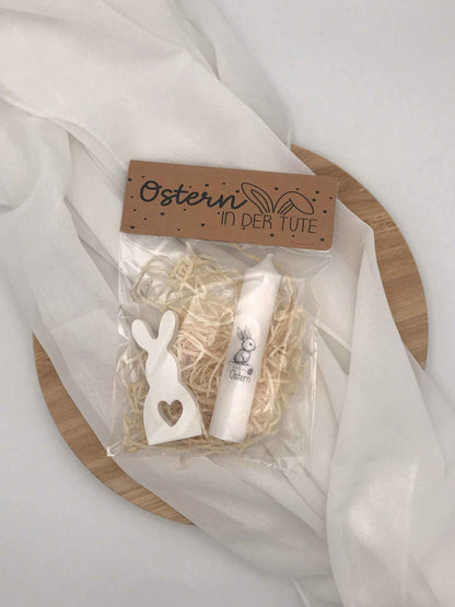 Easter gift set with handmade bunny decoration and candle on wood base.