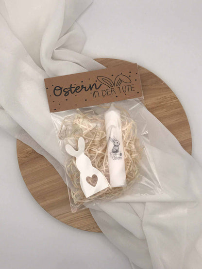 Easter gift set with decorative bunny and candle in a gift box.