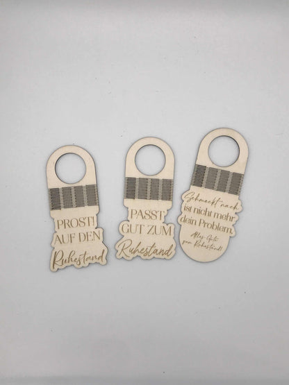 Personalisierte Flaschenanhänger aus Holz mit Aufschriften zum Ruhestand. Perfektes Geschenk für besondere Anlässe.