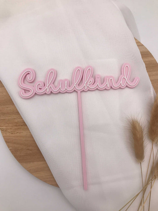 Pink 3D printed "Schulkind" cake topper made from biodegradable PLA, perfect for school enrollment cake decoration.