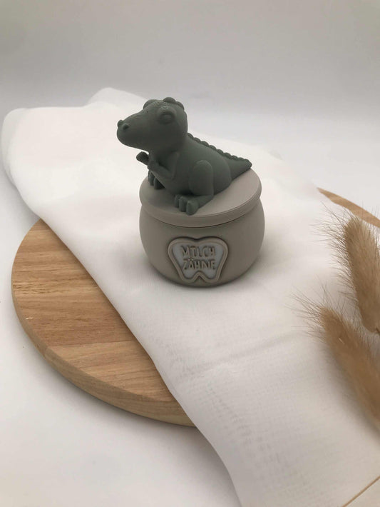 3D-printed biodegradable PLA milk tooth box for children with cute dinosaur lid, compact size, gray color.