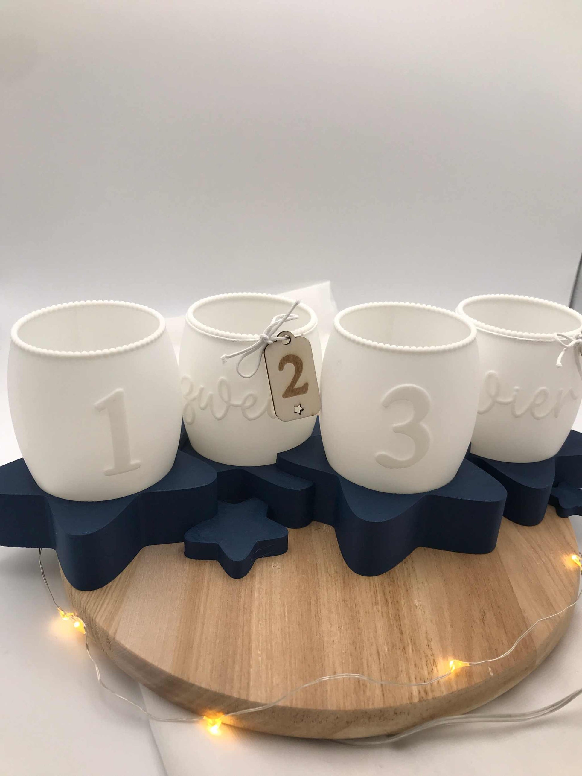 Moderner Adventskranz 3D Druck aus weißem PLA mit Zahlen 1 bis 4 auf dunkelblauem Sternenständer, umweltfreundliche Weihnachtsdeko